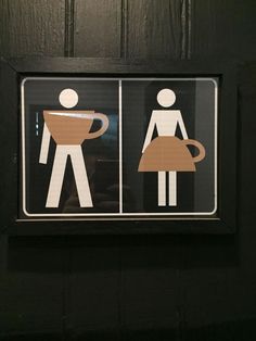 two stickers on the side of a door depicting people drinking coffee and holding a cup