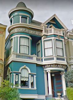 a large blue and white house with many windows