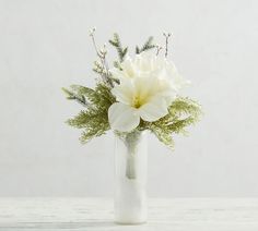 a white flower arrangement in a glass vase