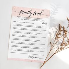 a wedding game with the bride's names on it next to some dried flowers