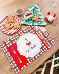 the table is set for christmas with cookies, candy and other holiday treats on it