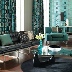 a living room filled with furniture next to a wall covered in blue and green curtains