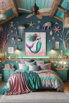 a bedroom decorated with mermaid themed decor