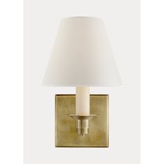 a wall light with a white shade on it