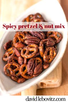 spicy pretzel and nut mix in a white bowl