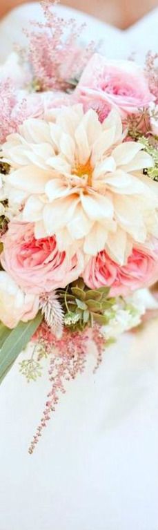 a bridal bouquet with pink and white flowers on it's lapel cover