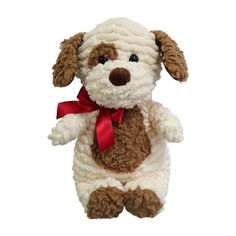 a brown and white dog stuffed animal with a red ribbon around its neck on a white background