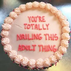 a cake with writing on it that says you're totally nailing this adult thing