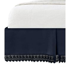 an image of a bed with white sheets and blue bedspread on top of it