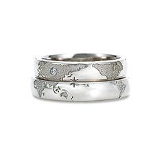 two silver rings with an image of the world on them