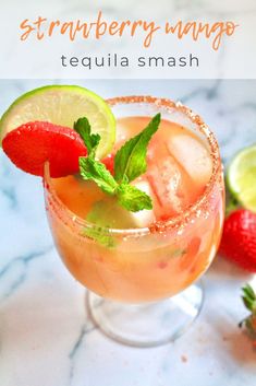 the strawberry mango tequila is garnished with lime and strawberries