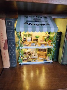 a book shelf with books and a store sign on the front cover that says bloom's