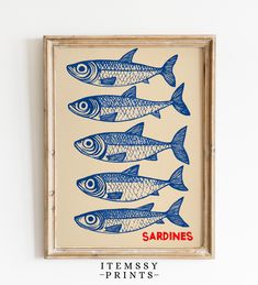 blue fish are lined up in a row against a white wall with the words sardines on it