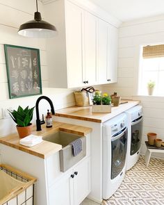 a kitchen with white cabinets and wood counter tops on the bottom right corner is an instagram page