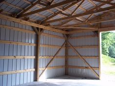 the inside of a building that is being built with wood and metal panels on it