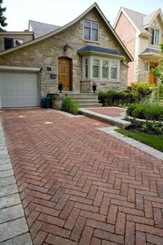 a brick driveway in front of a house