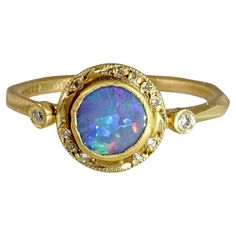 Bluish Purple, 0.60ct Round Australian Boulder Opal, Stackable Ring with Diamond Detail, 24K Solid, Yellow Gold. One of a Kind Ring. This piece would make a great stacker ring.   Details: Diamonds: 0.05ct (12 Diamonds) Opal: 0.60ct. Size: 6 1/2 (US) About Opal: In ancient times, this stone was believed to possess all the characteristics of all gemstones and is used because it represents hope, clarity, and truth. Queen Victoria is thought to have gifted her five daughters' opal jewelry at their w Mexican Opal Ring, Boulder Opal Ring, Unique Mens Rings, Bluish Purple, Stackable Diamond Rings, Big Jewelry, Platinum Diamond Rings, Australian Boulder Opal, Opal Earrings Stud