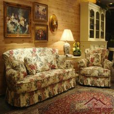 a living room with two couches and a rug in front of the fireplace area