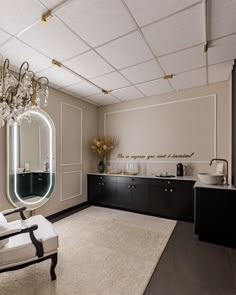 an elegant bathroom with chandelier, mirror and vanity in black and white colors