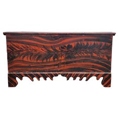 an old wooden chest with carved designs on the front and sides, isolated against a white background