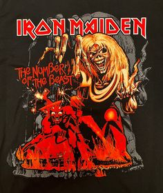 iron maiden the number of the beast t - shirt on display at an auction store