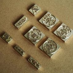 several metal stamp sets sitting on top of a table