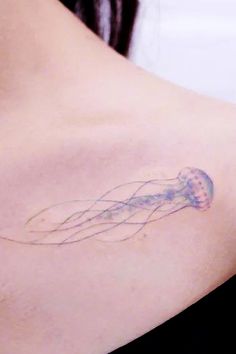 a woman with a tattoo on her chest has a jellyfish in it's stomach