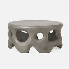 an unusual coffee table with holes in the top and bottom, on a white background