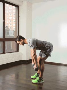 a man riding a skateboard on top of a wooden floor next to a window