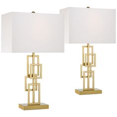 two lamps that are next to each other on a white background, one is gold and the other is white