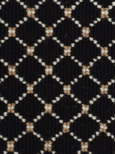 black and white checkered fabric with gold dots on it's edges, closeup