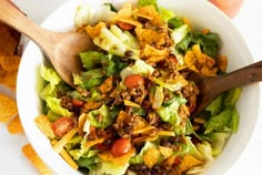 a white bowl filled with salad and chips