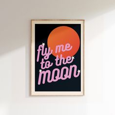 a framed poster with the words fly me to the moon