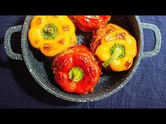 several peppers in a pan on a blue table cloth