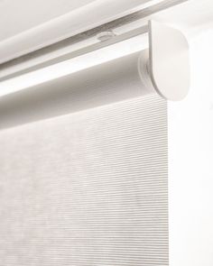 a close up view of a closed window with white blinds