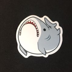 a sticker depicting a shark with its mouth open and it's teeth out