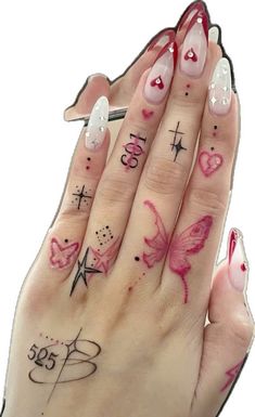 a woman's hand with tattoos on it and two fingers that have different designs