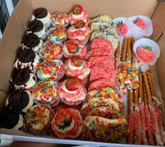 a box filled with lots of different types of pastries and desserts on top of it