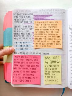 an open bible book with sticky notes on the pages and words written in different colors