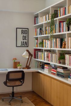 a chair sitting in front of a bookshelf filled with lots of books next to a desk