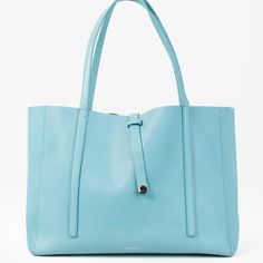 This Bright And Beautiful Tote Bag From Tiffany & Co Features An All Leather Upper In Their Signature Turquoise Blue, Double Top Handles, Rope And Loop Closure, And Spacious Interior Black Leather Lining With An Additional Zipper Closure Pouch And Two Slip Pockets. Condition: Good; Leather On The Top Rim Of The Bag Is Cracked, Handles And Body Of The Bag Are Stained. Includes Dust Bag. Approximate Measurements: Height: 10.75" (27 Cm) Width: 18" (45.75 Cm) Depth: 6" (15 Cm) Handle Drop: 9.5" (24 Tiffany Bag, Tiffany And Co, East West, Shopping Tote, Metal Hardware, Tiffany & Co., Turquoise Blue, Womens Tote Bags, Limited Time