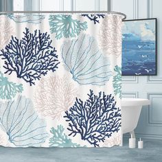 a shower curtain with blue and white corals on it in front of a bathtub