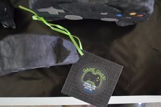 a game controller sitting on top of a black cloth covered table next to a tag