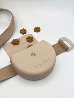 a beige belt with buttons on it and some other items around it that are laying on the ground