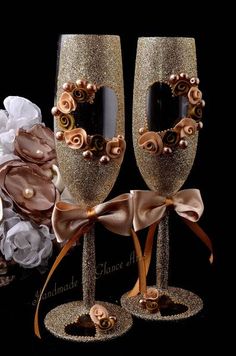 two champagne flutes decorated with flowers and ribbons