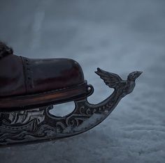 an antique sleigh with a bird on it