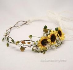 sunflowers and baby's breath flowers are arranged on a headband with lace