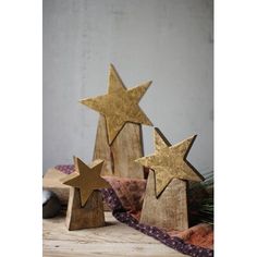 three wooden stars sitting on top of a table