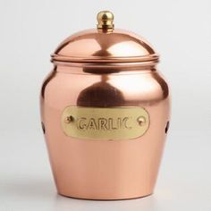 a large metal container with the word garlic on it's side and a gold plated lid