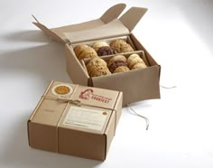 a box filled with lots of different types of doughnuts next to each other